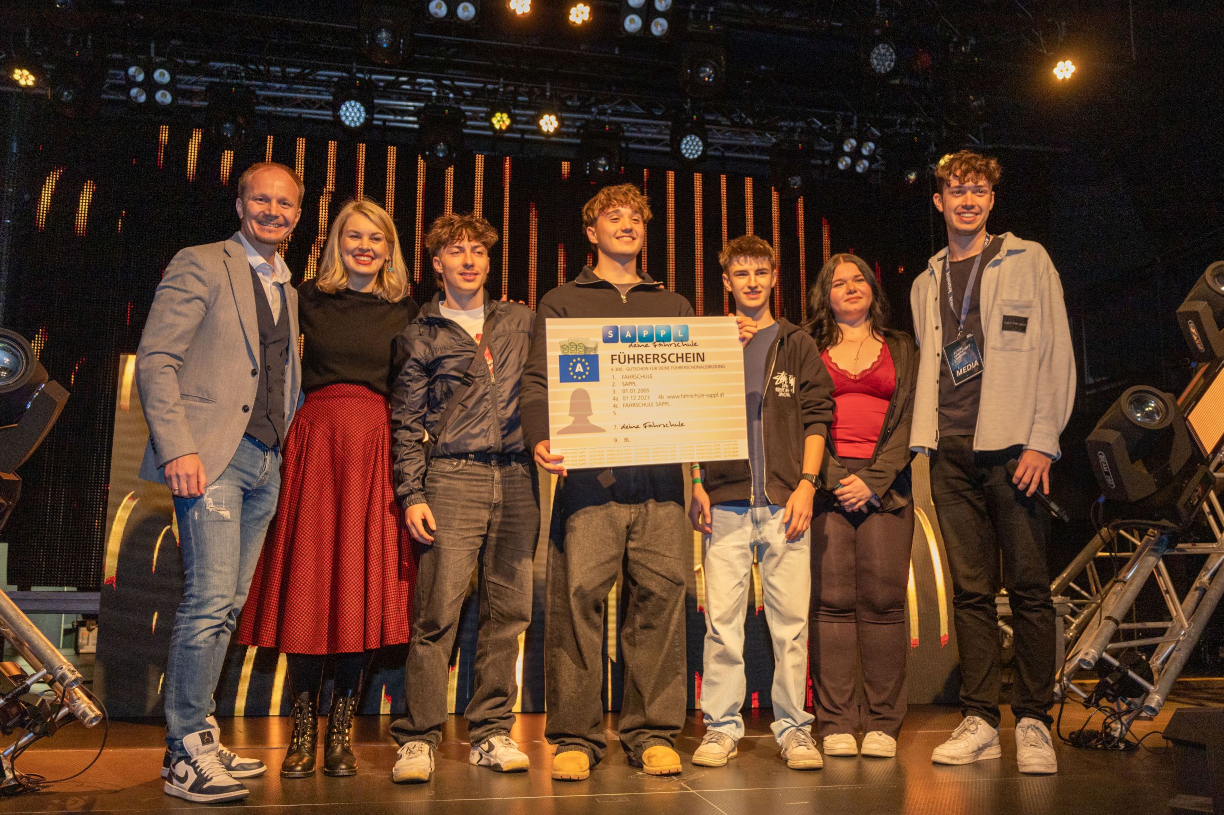 Zwei Jungbürger staubten die Hauptpreise des Gewinnspiels ab: Tickets für das „Electric Love“-Festival und einen Führerschein-Gutschein im Wert von 300 Euro. Bürgermeister Johannes Anzengruber (l.), Vizebürgermeisterin Elisabeth Mayr (2.v.l.), Moderator Patrick Scharf (alias DJ Spicy, r.) und die beiden VertreterInnen des Innsbrucker Jugendbeirats, Florian Jäger (3.v.r.) und Antonella Cizmesinkin (2.v.r.) freuten sich mit den Gewinnern.