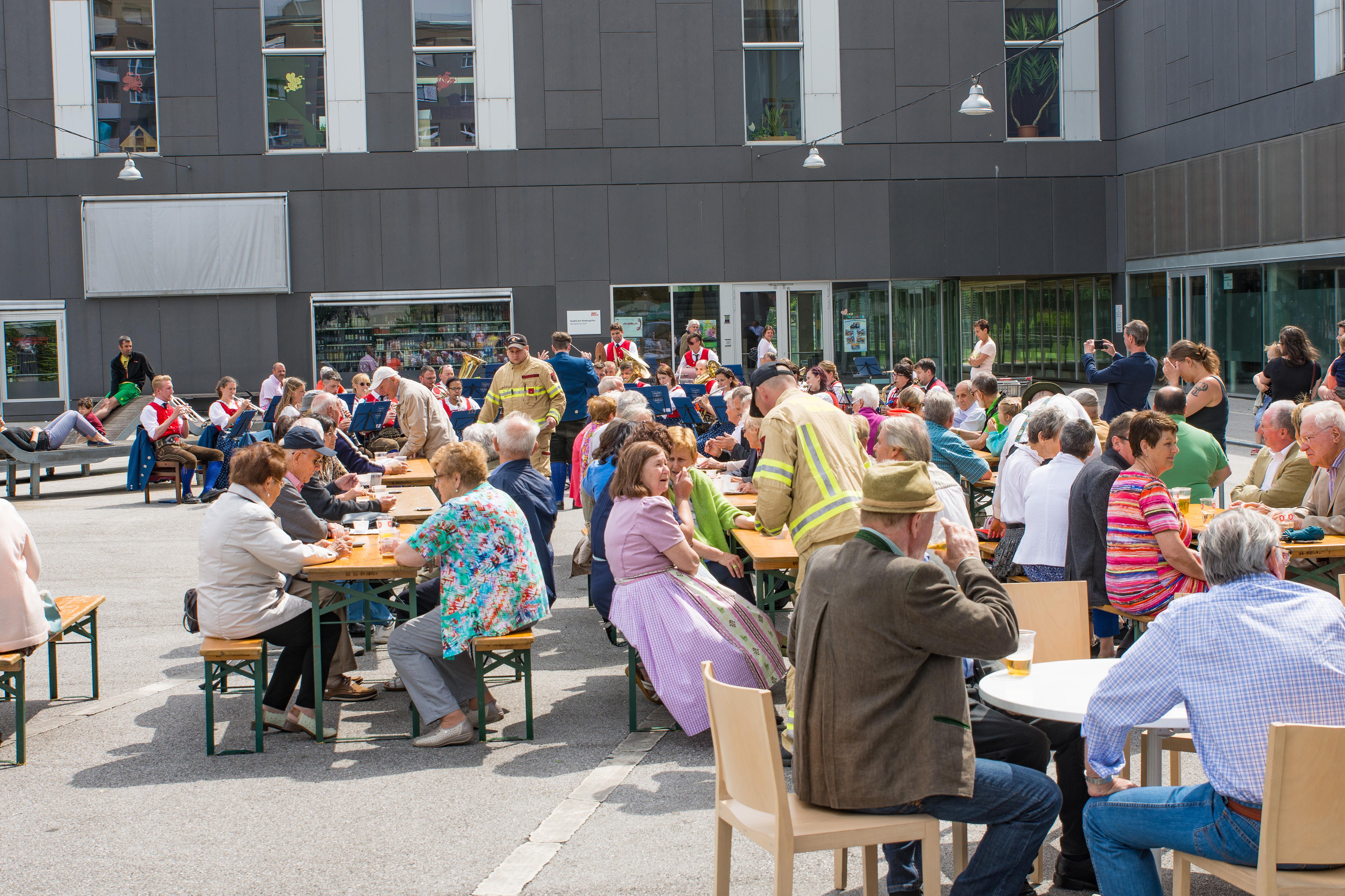 Vizebürgermeister Christoph Kaufmann eröffnete das Platzkonzert der Speckbacher Musikkapelle am DDr. Alois Lugger Platz. Gemeinsam mit der Pfarre St. Pius X und der Freiwilligen Feuerwehr Neu Arzl organisierte die Speckbacher Musikkapelle einen Frühschoppen im Olympischen Dorf .